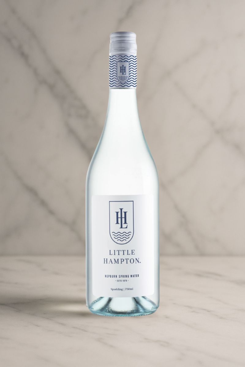 Premium 750ml Little Hampton Spring Water bottle on a marble background, showcasing limited-edition Australian spring water in elegant glass packaging.